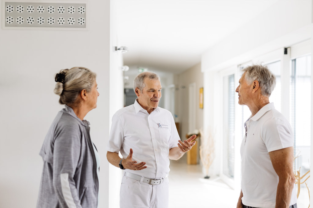 Doctor talks to two patients