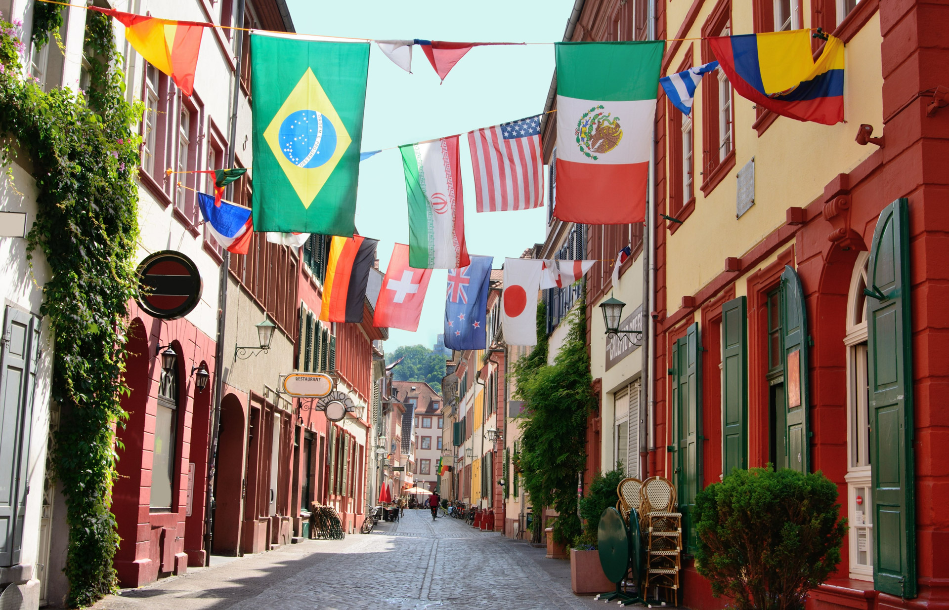 Various country flags hanging in a side street in the old town