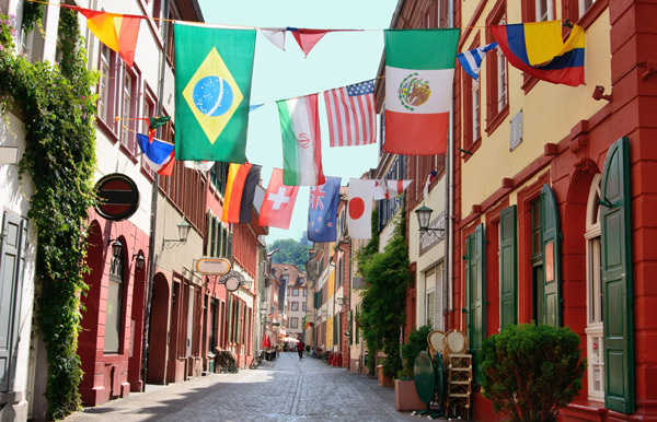 Various country flags hanging in a side street in the old town